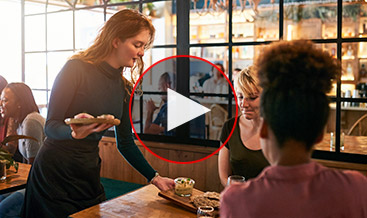 A waitress serving a table at a restaurant